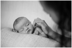newborn baby opening eye when feeling mums touch