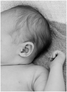newborn babies ear, black and white close up photo of baby